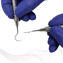 Dental tools held by gloved hands on a white background